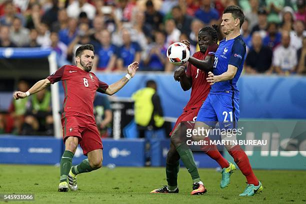 Portugal's midfielder Joao Moutinho eyes the ball as Portugal's forward Eder touches the ball as he is tackled by France's defender Laurent Koscielny...
