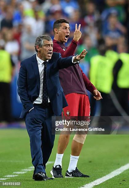 Cristiano Ronaldo and manager Fernando Santos gestures on the touchline during the UEFA EURO 2016 Final match between Portugal and France at Stade de...