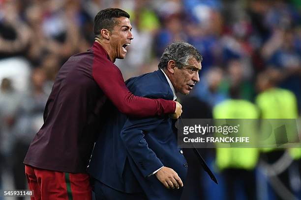 Portugal's forward Cristiano Ronaldo and Portugal's coach Fernando Santos react as the team win 1-0 over France during the Euro 2016 final football...