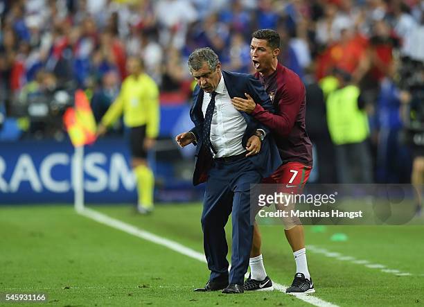 Manager Fernando Santos and Cristiano Ronaldo of Portugal celebrate winning at the final whistle during the UEFA EURO 2016 Final match between...