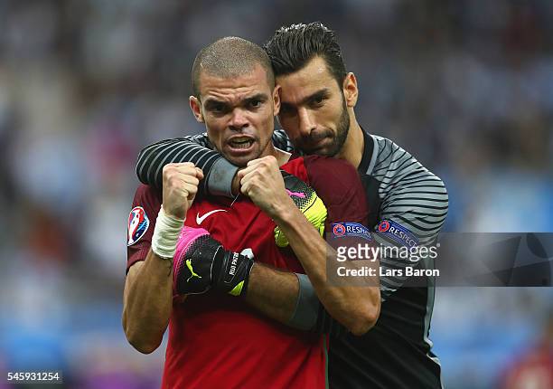 Pepe and Rui Patricio of Portugal celebrate winning at the final whistle during the UEFA EURO 2016 Final match between Portugal and France at Stade...