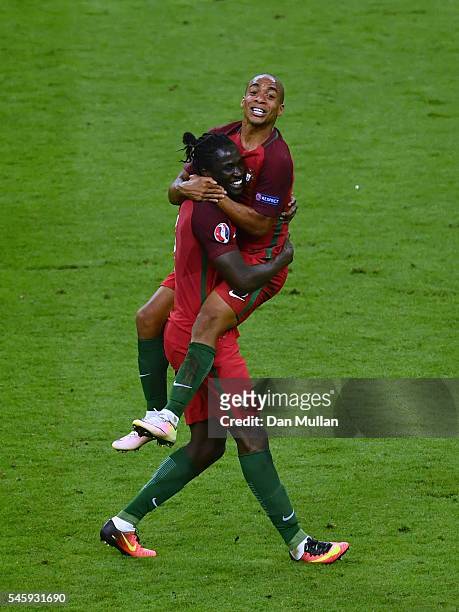 Eder and Joao Mario of Portugal celebrate winning after the UEFA EURO 2016 Final match between Portugal and France at Stade de France on July 10,...