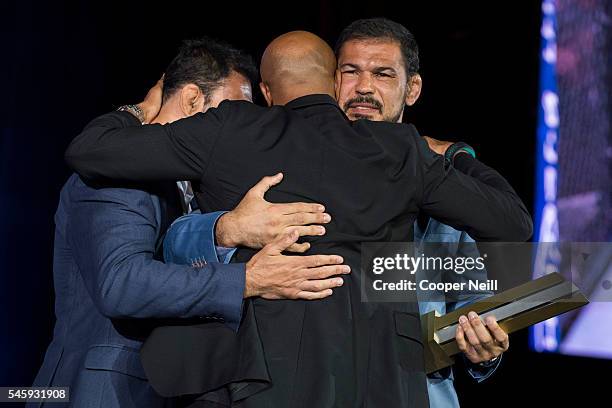 Antonio Rodrigo "Minotauro" Nogueira gets a hug from his brother Antonio Rogerio Nogueira and Anderson Silva as he is inducted into the UFC Hall of...