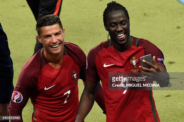 Portugal's forward Cristiano Ronaldo and Portugal's forward Eder take a selfie as they arrive to receive their medals after the Euro 2016 final...