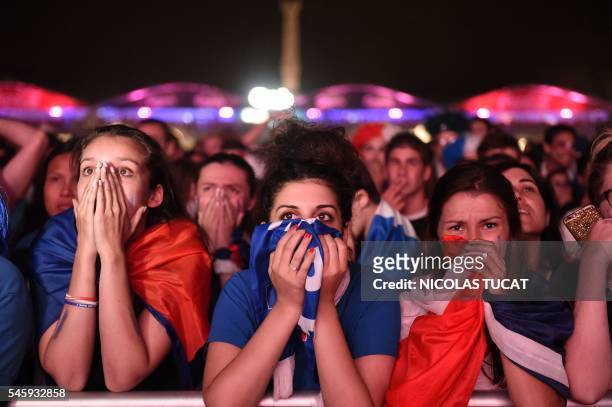 France's supporters react following the Euro 2016 final football match between France and Portugal at the fan zone in Bordeaux on July 10, 2016.