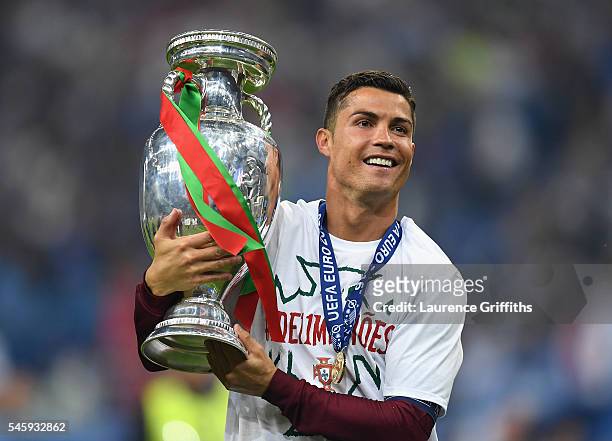 Cristiano Ronaldo of Portugal holds the Henri Delaunay trophy to celebrate after his team's 1-0 win against France in the UEFA EURO 2016 Final match...