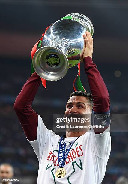 Cristiano Ronaldo of Portugal lifts the Henri Delaunay trophy to celebrate after his team's 1-0 win against France in the UEFA EURO 2016 Final match...