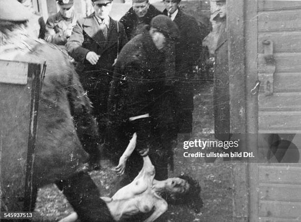 World War II, Warsaw Ghetto during the German occupation: the dead body of a woman is carried off