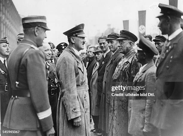 Germany, Third Reich - Nuremberg Rally 1937 Adolf Hitler talking to construction workers who were building the 'Autobahn' during a parade of the...
