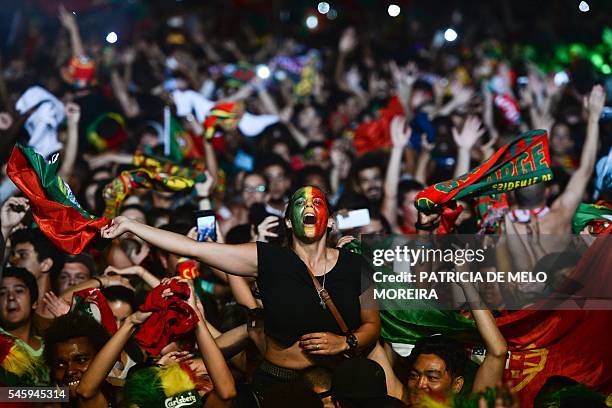 Portugal's national football team supporters celebrate their team's victory at Terreiro do Paco square in Lisbon on July 10, 2016 after watching on a...