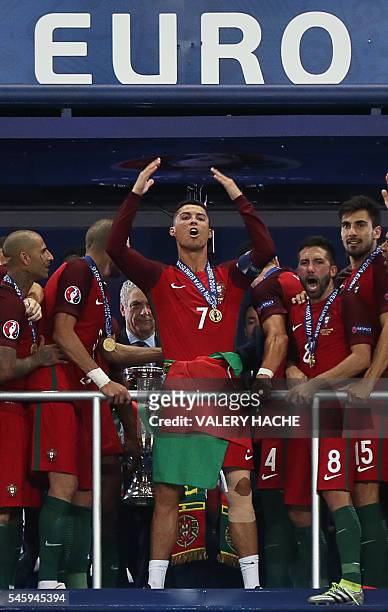 Portugal's midfielder Andre Gomes, Portugal's midfielder Joao Moutinho and Portugal's forward Cristiano Ronaldo celebrate after they beat France...
