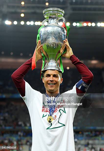 Cristiano Ronaldo of Portugal holds the Henri Delaunay trophy to celebrate after his team's 1-0 win against France in the UEFA EURO 2016 Final match...
