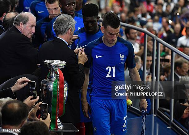 First vice president Angel Maria Villar presents France's defender Laurent Koscielny and France's defender Samuel Umtiti with medals during the...