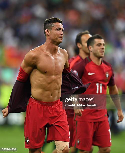 Cristiano Ronaldo of Portugal takes off his shirt to celebrate winning at the final whistle after the UEFA EURO 2016 Final match between Portugal and...