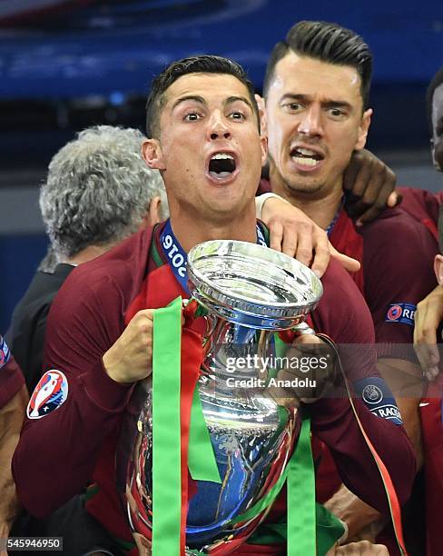 Portugal's forward Cristiano Ronaldo celebrates with the trophy as he poses after Portugal won the Euro 2016 final football match between Portugal...