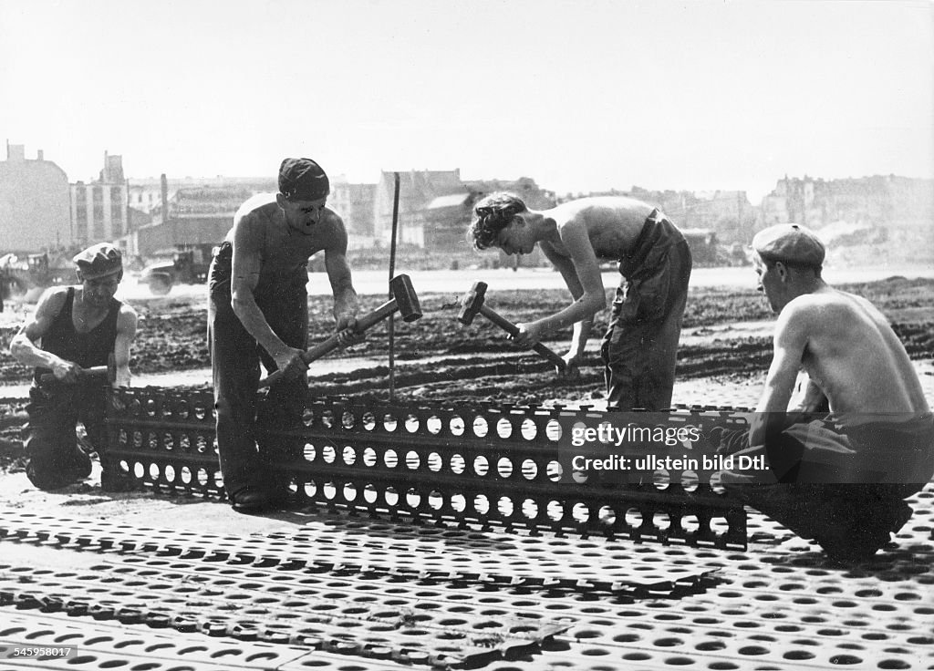Berlin Blockade Contruction of a 2km long, second taxiway for supply planes at Tempelhof Airport. Shown: laying steel mats in order to adjust the unevenness