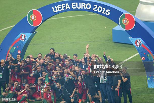 Portugal's players pose with the trophy as they celebrate after beating France during the Euro 2016 final football match at the Stade de France in...