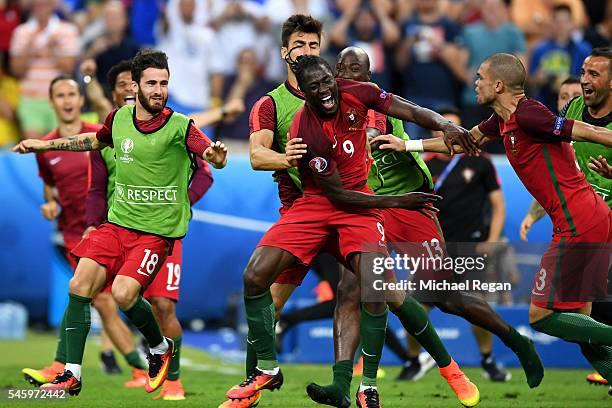 Eder of Portugal celebrates scoring the opening goal with his team mates during the UEFA EURO 2016 Final match between Portugal and France at Stade...