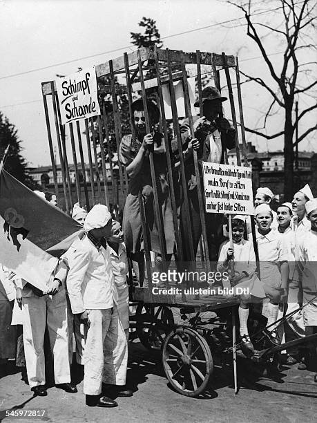 Germany, Post War Years in Berlin 1945-49 Bakers demonstrating against West Berlin cititzens - symbolically displayed in a cage or 'pillory' - who go...