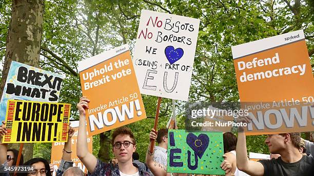 Pro-European Union supporters and pro-Brexit supporters hold up placards during a demonstration against Brexit in Green Park in London on July 9,...