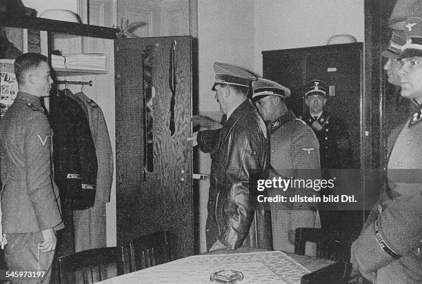 Adolf Hitler visits the 'Leibstandarte SS Adolf Hitler' in their barracks in Berlin-Lichterfelde: checking the wardrobes; next to Hitler, r: the...