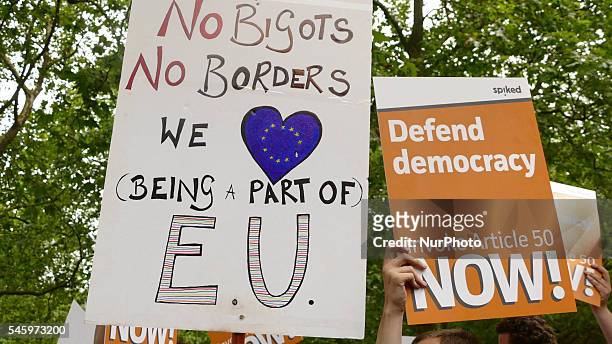 Pro-European Union supporters and pro-Brexit supporters hold up placards during a demonstration against Brexit in Green Park in London on July 9,...