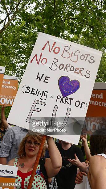 Pro-European Union supporters and pro-Brexit supporters hold up placards during a demonstration against Brexit in Green Park in London on July 9,...