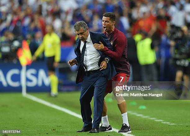 Manager Fernando Santos and Cristiano Ronaldo of Portugal celebrate winning at the final whistle during the UEFA EURO 2016 Final match between...