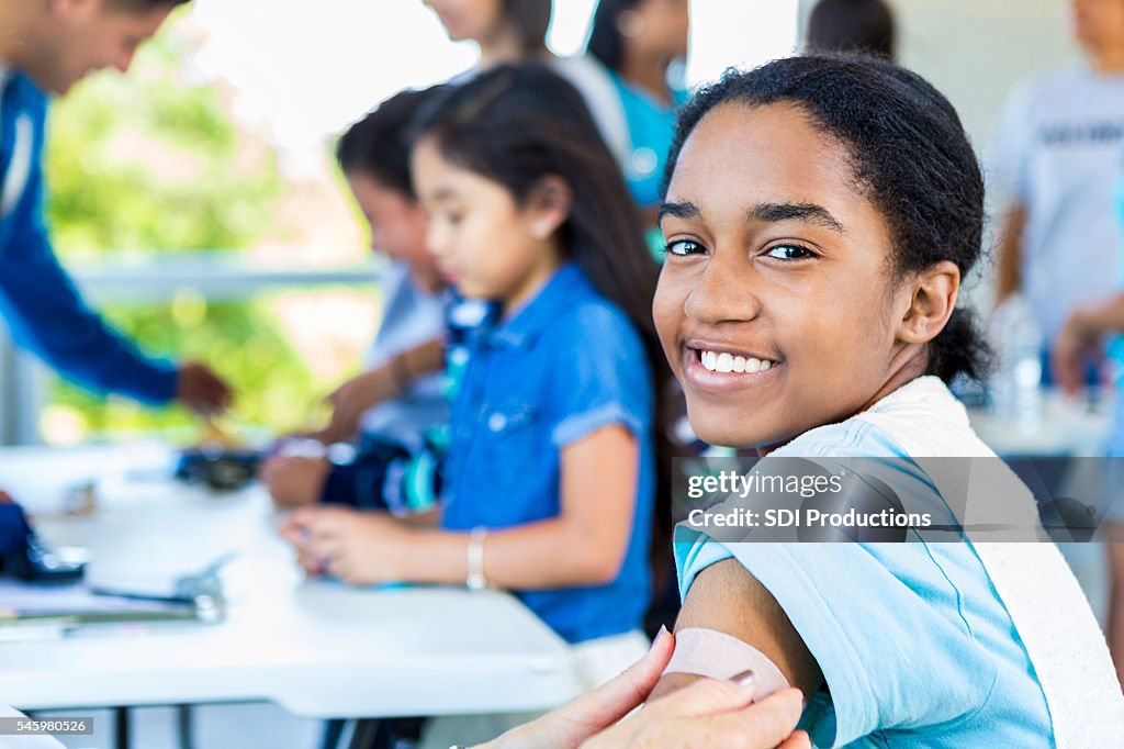 Smiling African American Girl after getting a vaccination