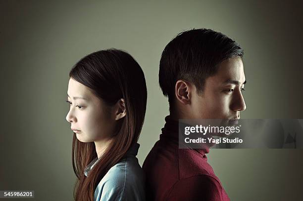 man and woman feeling sad in back to back - back to back stock pictures, royalty-free photos & images