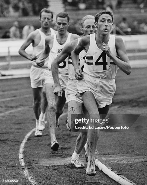 English Long-distance runner Ron Hill leads Basil Heatley of Great Britain, Buddy Edelen of the USA, and N. Sargent, also of the USA, during the...