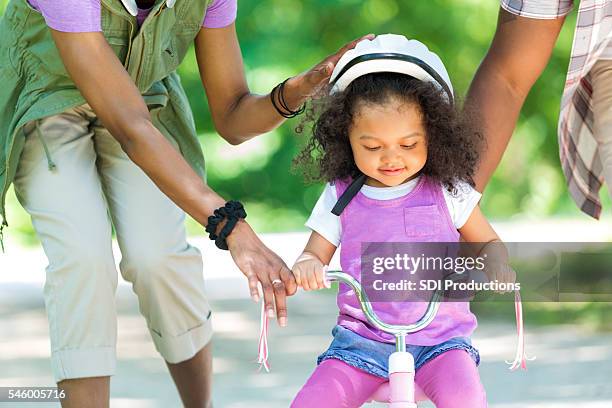 toddler daughter learning to ride a tricycle - community safety stock pictures, royalty-free photos & images