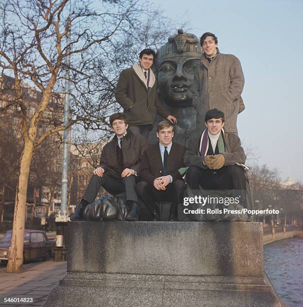English pop group The Dave Clark Five posed on a sphinx on the Embankment beside the river Thames in London circa 1964. Clockwise from top left:...