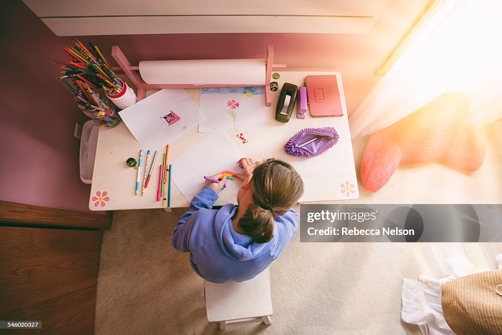 Girl drawing at desk