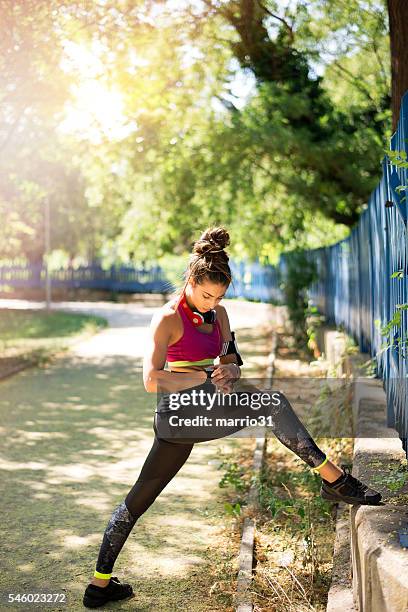 woman setting up the fitness smart watch - waist stockfoto's en -beelden