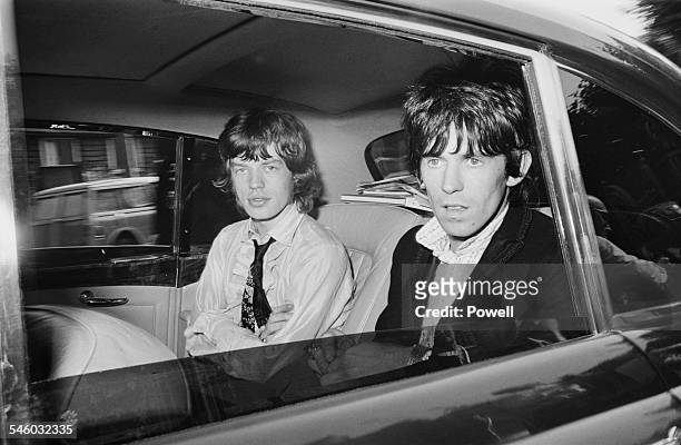 Singer Mick Jagger and guitarist Keith Richards of British rock group the Rolling Stones leaving Wormwood Scrubs prison after being released on...