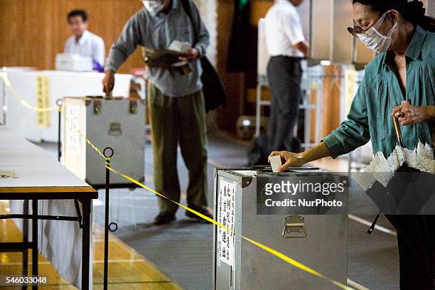 Voters cast their ballots to vote for parliaments upper house election at a polling station in Tokyo, Japan on July 10, 2016. The revised law has...