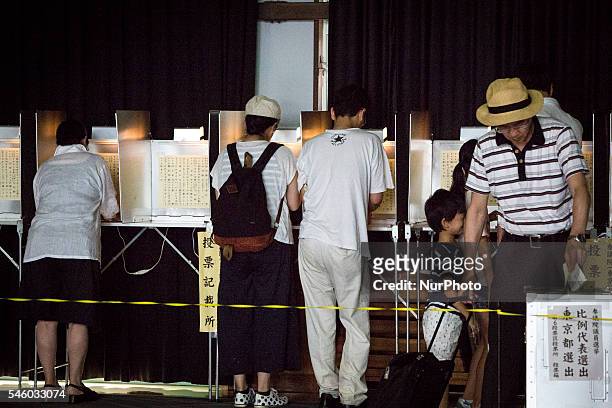 Voters cast their ballots to vote for parliaments upper house election at a polling station in Tokyo, Japan on July 10, 2016. The revised law has...