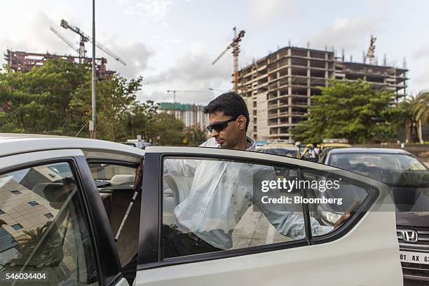 Vishal Agrawal, a foreign exchange trader at Standard Chartered Plc, enters an Uber Technology Inc. Taxi in Mumbai, India, on Thursday, June 9, 2016....