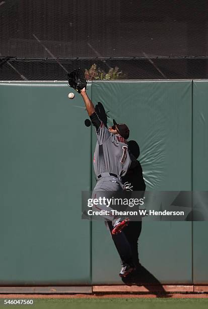 Michael Bourn of the Arizona Diamondbacks collides with the wall going after this ball that goes for a double off the bat of Angel Pagan of the San...