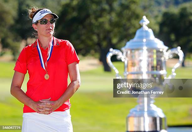 Brittany Lang poses with the trophy on the 18th green after defeating Anna Nordqvist of Sweden in a three hole playoff to win the U.S. Women's Open...