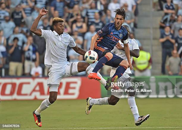 Forward David Villa of the New York City FC battles for the ball against defender Saad Abdul-Salaam of Sporting Kansas City during the first half on...