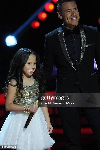 Finalist Carmen Sanchez and host Jorge Bernal smile during Telemundo "La Voz Kids" Finale at Universal Orlando on July 9, 2016 in Orlando, Florida.