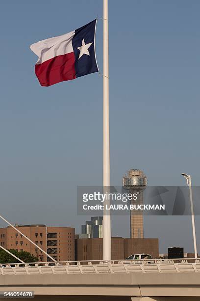 Texas state flag at Margaret Hunt Hill bridge in Dallas, Texas, flies at half mast on July 10 following the recent sniper attack on police officers....
