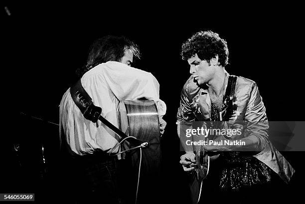 British musician John McVie and American musician Lindsey Buckingham, both from the group Fleetwood Mac, perform onstage at the Alpine Valley Music...