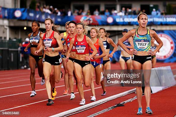 Nicole Tully walks inside the track after withdrawing as Molly Huddle, first place, and Emily Infeld, fourth place, and others compete in the Women's...