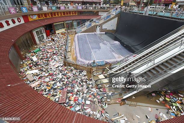 Shoes and bags float at a flooded shopping mall on July 10, 2016 in Xinxiang, China. An overnight rainstorm hit Xinxiang in central China's Henan...