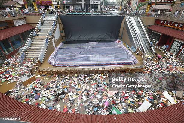 Shoes and bags float at a flooded shopping mall on July 10, 2016 in Xinxiang, China. An overnight rainstorm hit Xinxiang in central China's Henan...