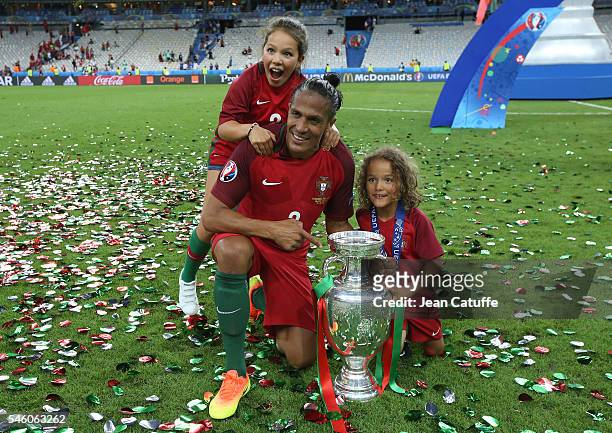 Bruno Alves of Portugal and his children pose with the trophy following the UEFA Euro 2016 final match between Portugal and France at Stade de France...