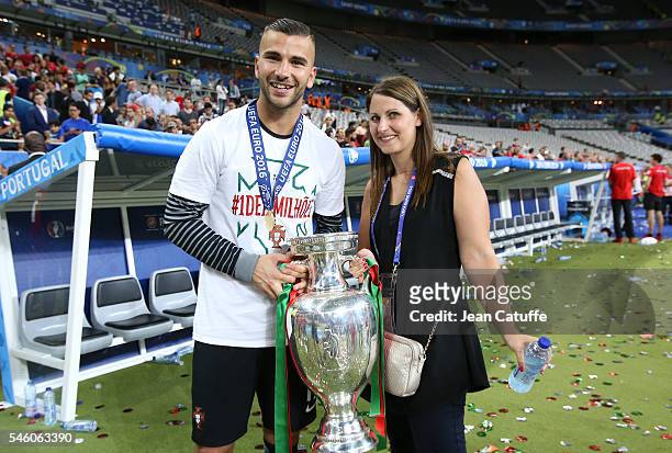 Goalkeeper of Portugal Anthony Lopes and his wife pose with the trophy following the UEFA Euro 2016 final match between Portugal and France at Stade...